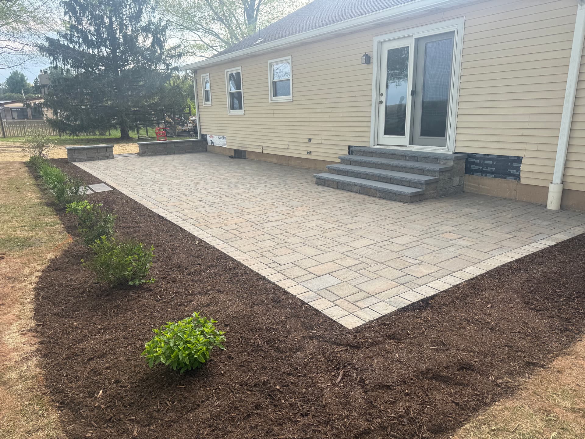 Gallery photos for Bare Backyard Gets a Paver Patio, Seating Wall, and Fresh Landscaping: Image #1