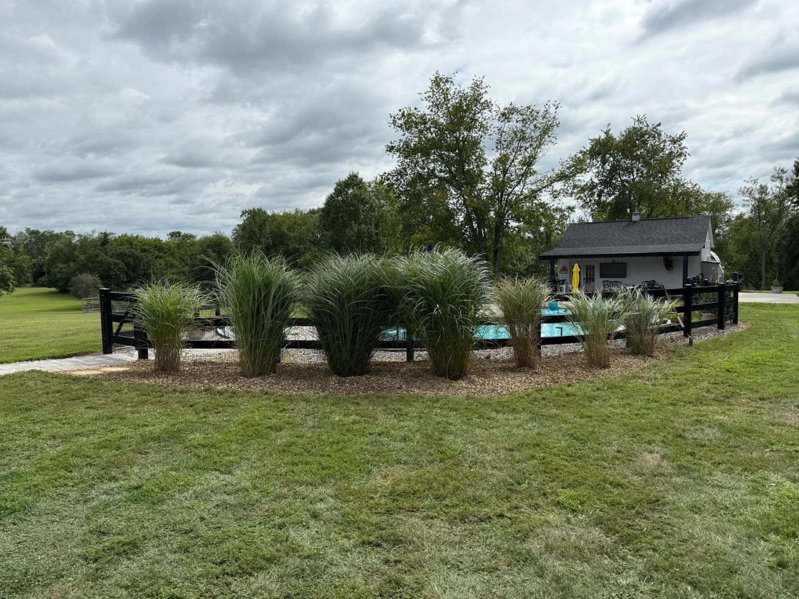 Backyard Oasis Transformation with River Rock Elegance image